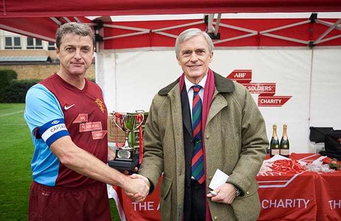 Colin Tadier from The Soldiers' Charity presenting the Charity Cup to the Army Crusaders capatin 