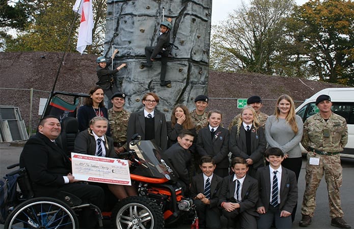 George Pas receiving cheque from pupils 